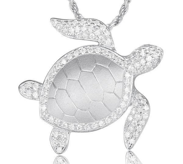 The picture shows a 925 sterling silver, white gold plated, sea turtle pendant with topaz.