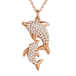 The picture shows a 925 sterling silver, rose gold vermeil, two dolphin pendant with topaz.