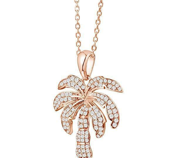 In this photo there is a rose gold palm tree pendant with topaz gemstones.