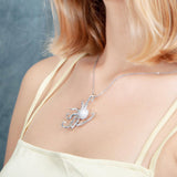 The picture shows a model wearing a 925 sterling silver pavé octopus pendant with topaz.