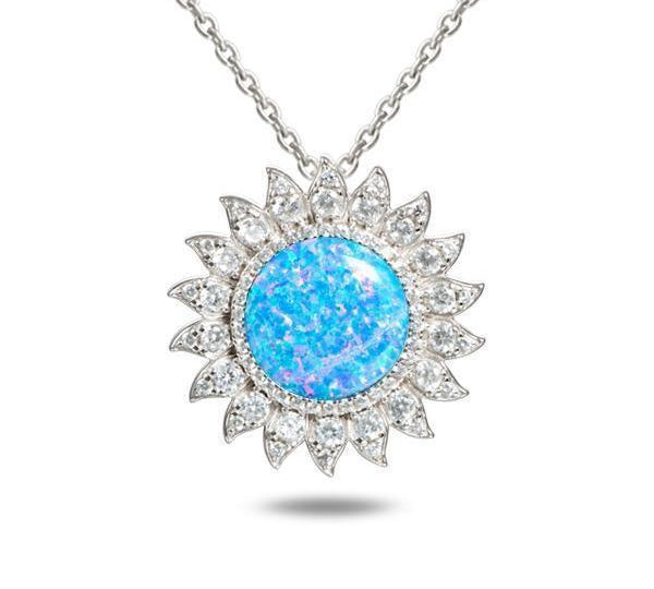 In this photo there is a sterling silver sunflower pendant with topaz and one blue opalite gemstone.