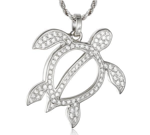 In this photo there is a white gold sea turtle pendant with topaz gemstones.