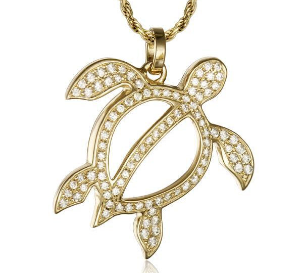 In this photo there is a yellow gold sea turtle pendant with topaz gemstones.