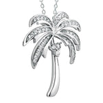 In this photo there is a white gold palm tree pendant with topaz gemstones.