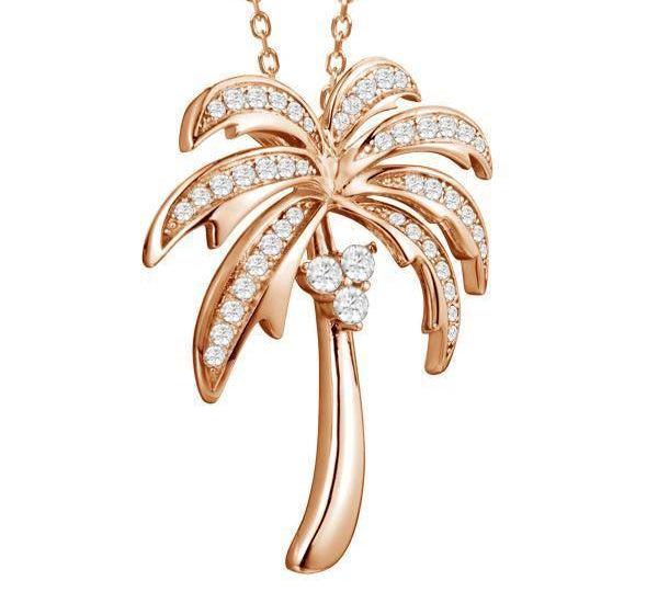 In this photo there is a rose gold palm tree pendant with topaz gemstones.
