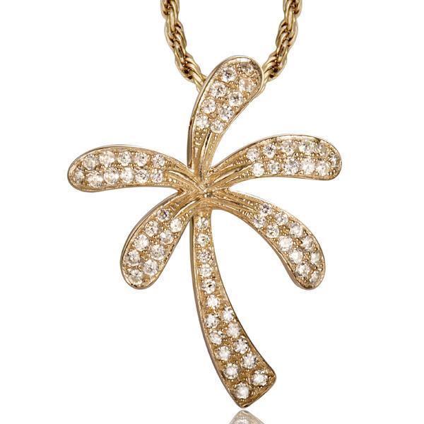 In this photo there is a yellow gold palm tree pendant with topaz gemstones.
