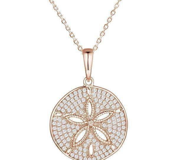 The picture shows a large 14K rose gold pavé sand dollar pendant with diamonds.