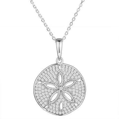 The picture shows a 14K white gold pavé sand dollar pendant with diamonds.