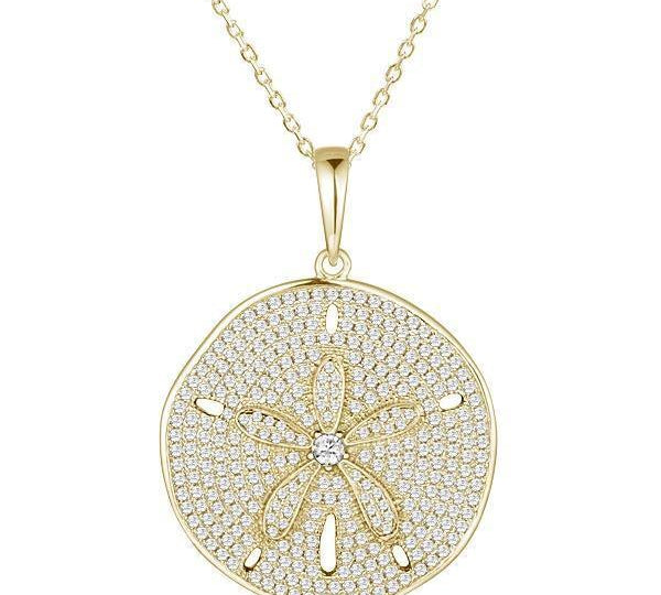 The picture shows a large 925 sterling silver, yellow gold vermeil, pavé sand dollar pendant with topaz.