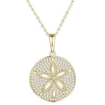 The picture shows a medium 925 sterling silver, yellow gold vermeil, pavé sand dollar pendant with topaz.