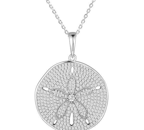 The picture shows a 14K white gold pavé sand dollar pendant with diamonds.