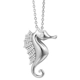 The picture shows a 925 sterling silver, white gold vermeil, pavé seahorse pendant with topaz.