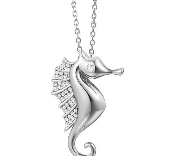 The picture shows a 925 sterling silver, white gold vermeil, pavé seahorse pendant with topaz.