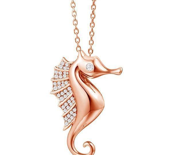 The picture shows a 925 sterling silver, rose gold vermeil, pavé seahorse pendant with topaz.