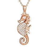 The picture shows a 925 sterling silver, rose gold vermeil, pavé seahorse pendant with topaz.