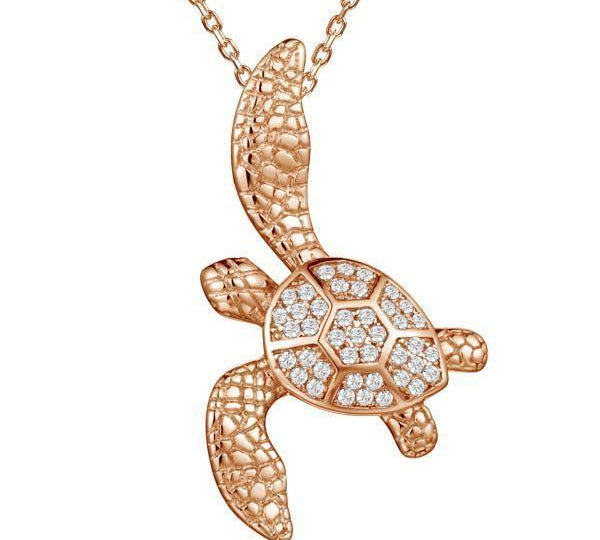 The picture shows a 925 sterling silver, rose gold vermeil, sea turtle pendant with topaz.