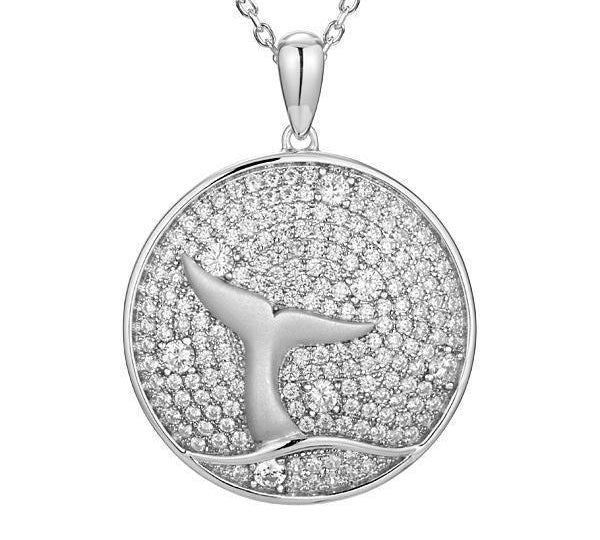 The picture shows a 925 sterling silver, white gold vermeil, pavé whale tail medallion pendant with topaz.