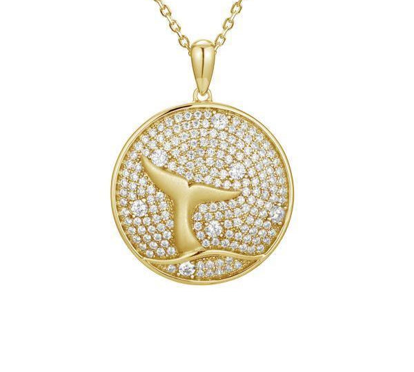 The picture shows a 925 sterling silver, yellow gold vermeil, pavé whale tail medallion pendant with topaz.