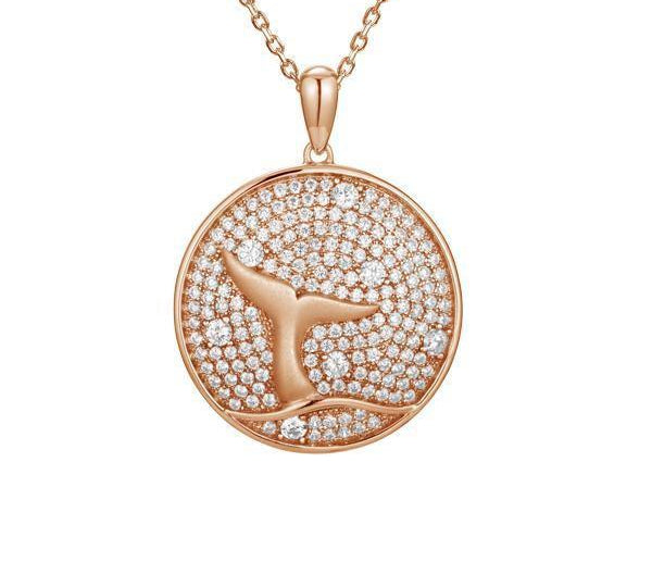 The picture shows a 925 sterling silver, rose gold vermeil, pavé whale tail medallion pendant with topaz.