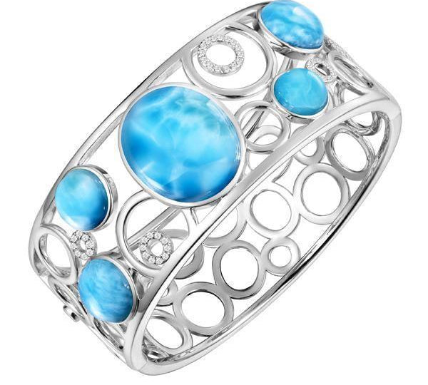 The picture shows a 925 sterling silver bangle with five larimar gemstones and topaz.