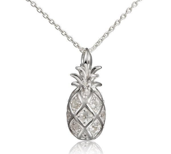 In this photo there is a sterling silver pineapple pendant with topaz gemstones.