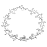 The photo shows a 925 sterling silver white gold-plated Polynesian sea turtle bracelet with topaz.