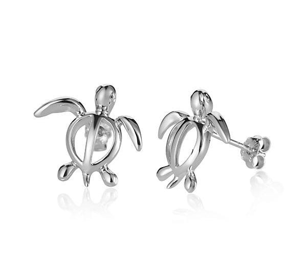 In this picture there is a pair of 14k white gold sea turtle stud earrings.