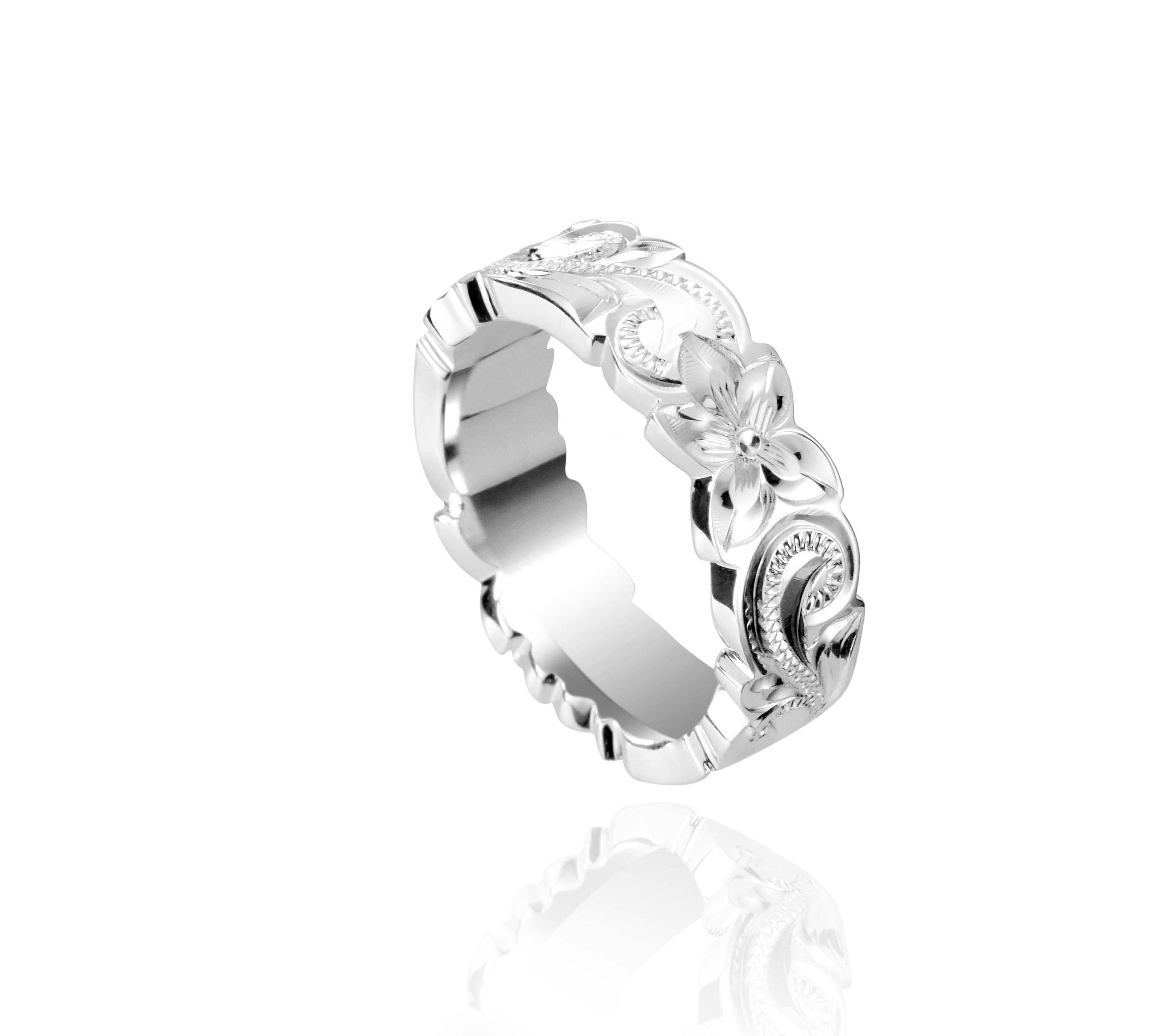 In this photo there is a sterling silver cut out ring with flower and scroll hand engravings.
