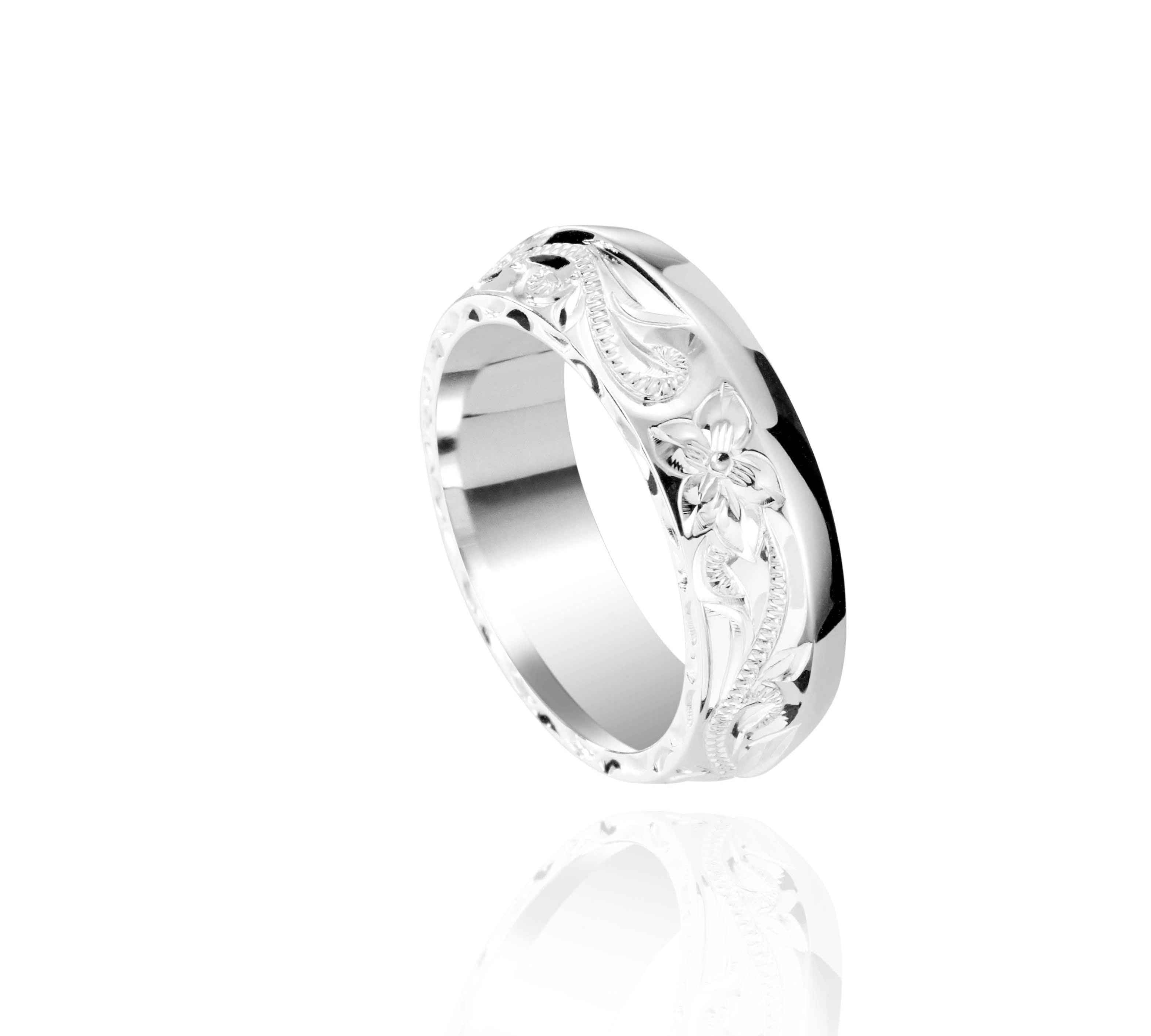 In this photo there is a sterling silver ring with flower and scroll hand engravings.