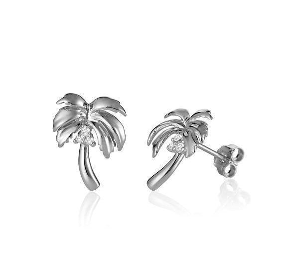 In this photo there is a pair of large 14k white gold queen palm tree stud earrings with diamond coconuts.