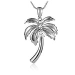 In this photo there is a sterling silver palm tree pendant with topaz gemstones.