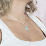 The picture shows a model wearing a 925 sterling silver larimar seahorse pendant.