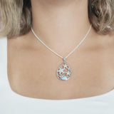 The picture shows a model wearing a 925 sterling silver teardrop three sea star pendant, with larimar gemstone, aquamarine, and topaz.