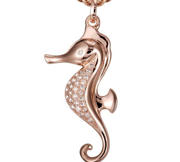 In this photo there is a rose gold seahorse pendant with topaz gemstones.