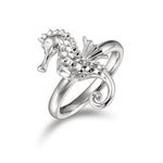 In this photo there is a 925 sterling silver seahorse ring with topaz eyes.