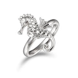 In this photo there is a 925 sterling silver seahorse ring with topaz eyes.