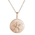 The picture shows a 14K rose gold sand dollar pendant with diamonds.