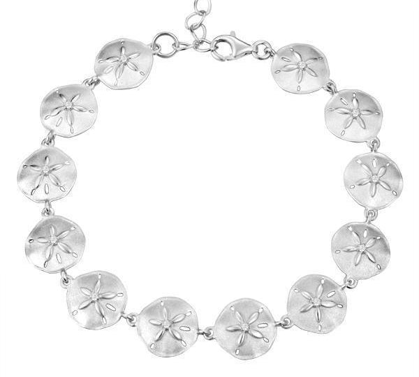 The picture shows a white gold sand dollar bracelet with topaz