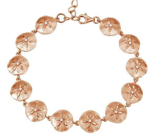 The picture shows a rose gold sand dollar bracelet with topaz