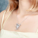 The picture shows a model wearing a 925 sterling silver swimming octopus pendant with topaz.