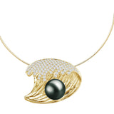In this photo there is a small yellow gold wave pendant with a dark pearl and diamonds.