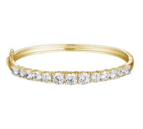 The photo shows a yellow gold tennis bracelet bangle with topaz.