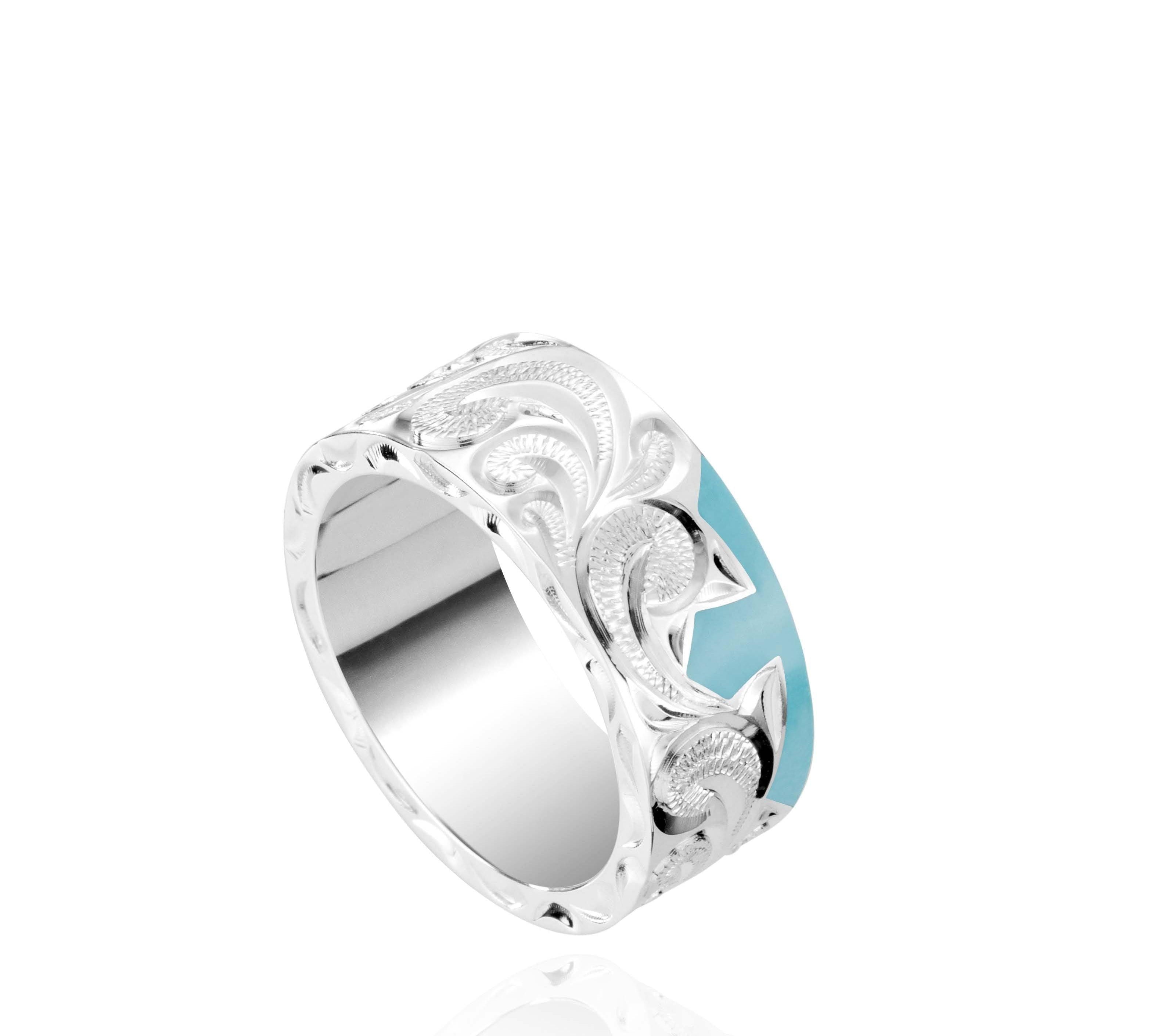 The picture shows a part of a set 925 sterling silver left half cross ring with hand-engravings and a turquoise gemstone.