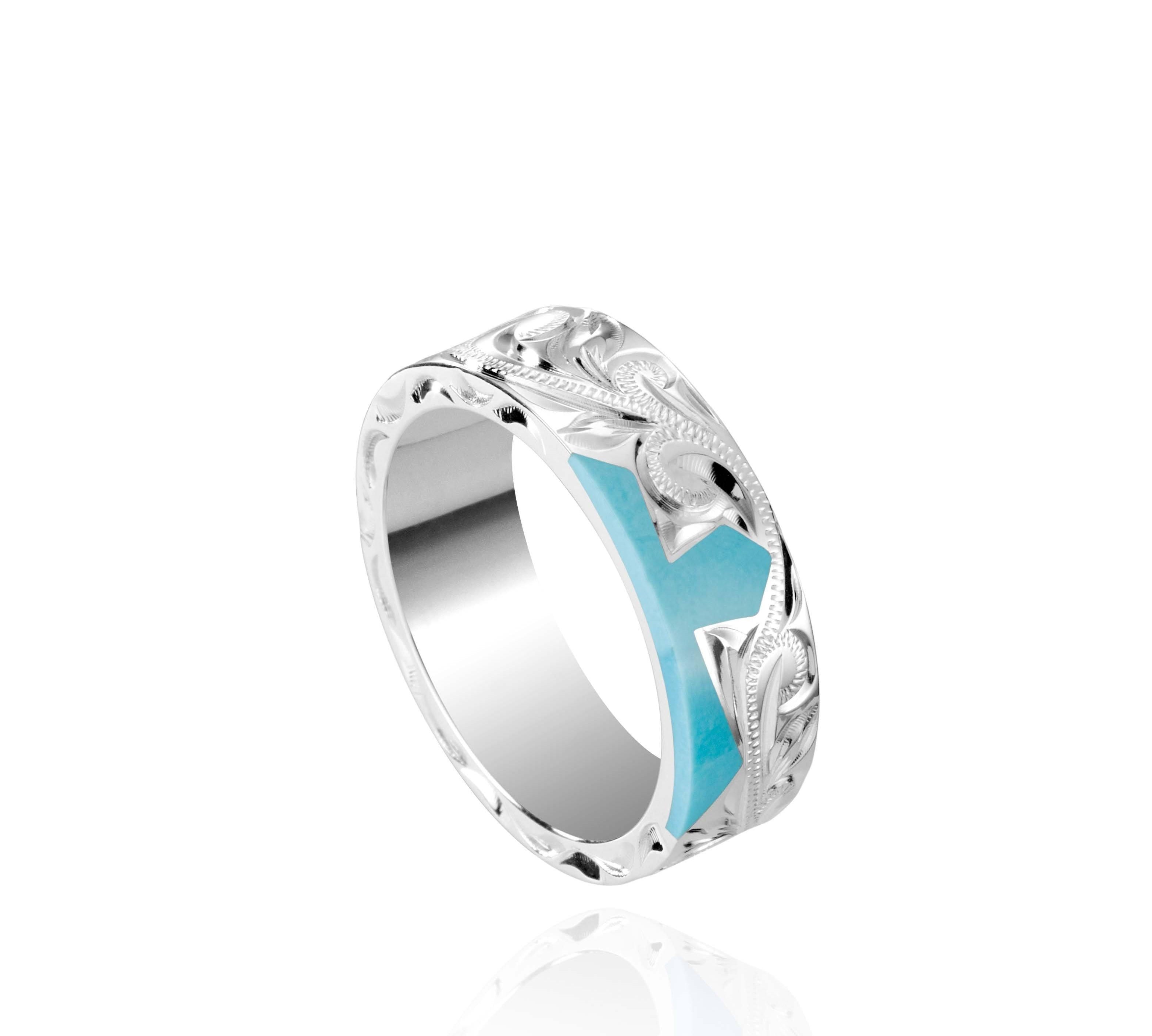 The picture shows a part of a set 925 sterling silver right half cross ring with hand-engravings and a turquoise gemstone.