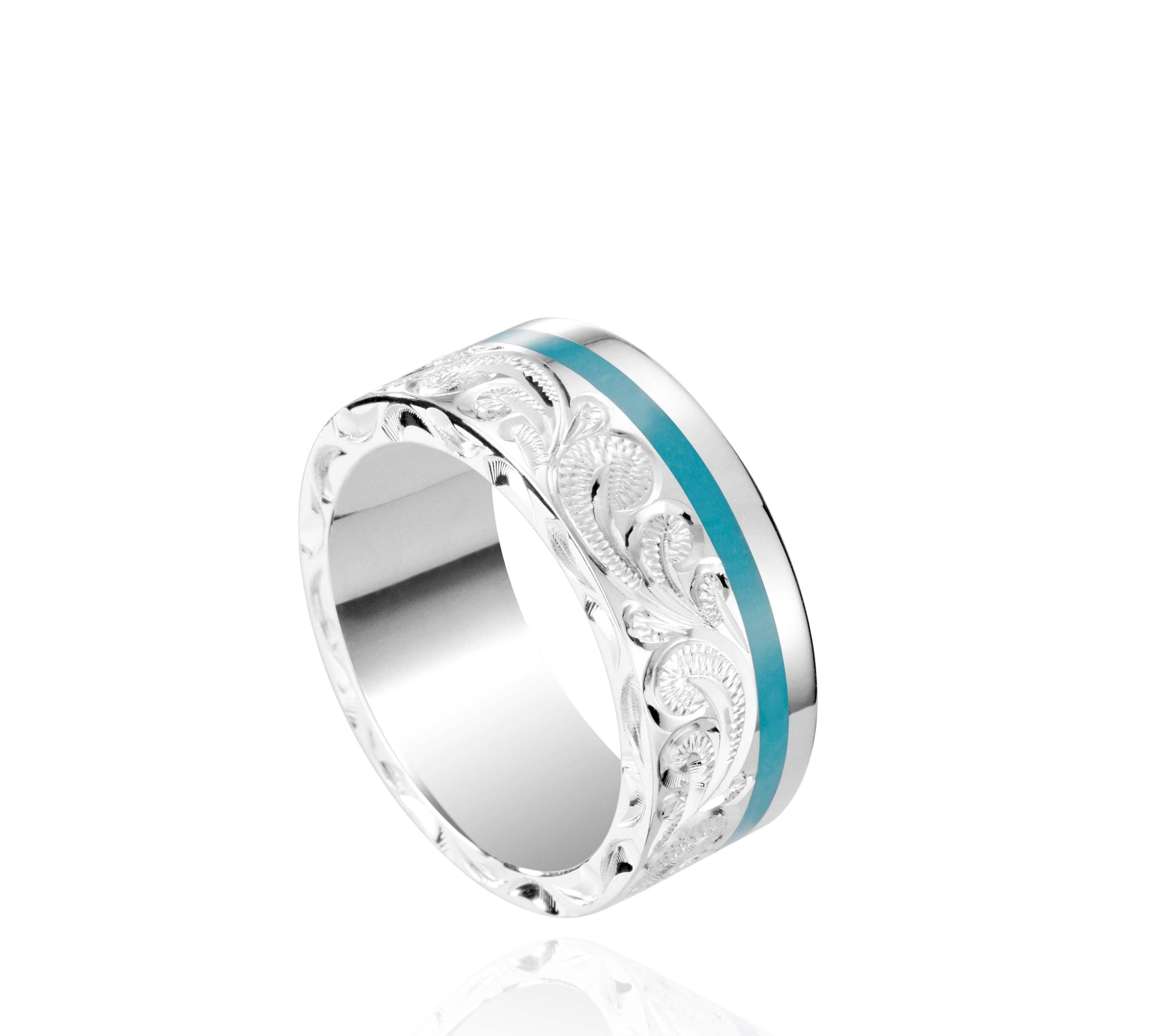 The picture shows a 925 sterling silver and turquoise wave channel ring with hand engravings.