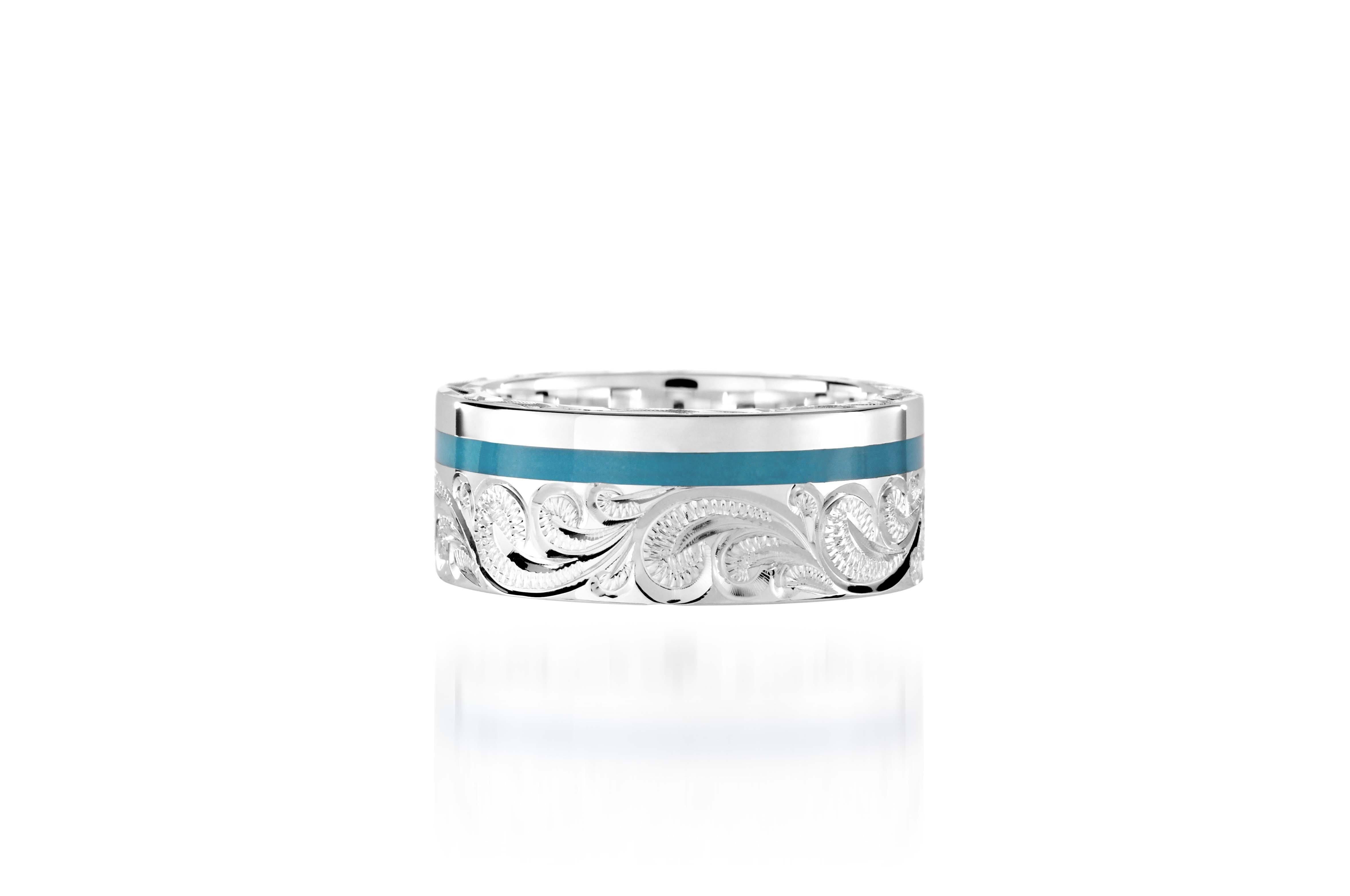 The picture shows a 925 sterling silver and turquoise wave channel ring with hand engravings.