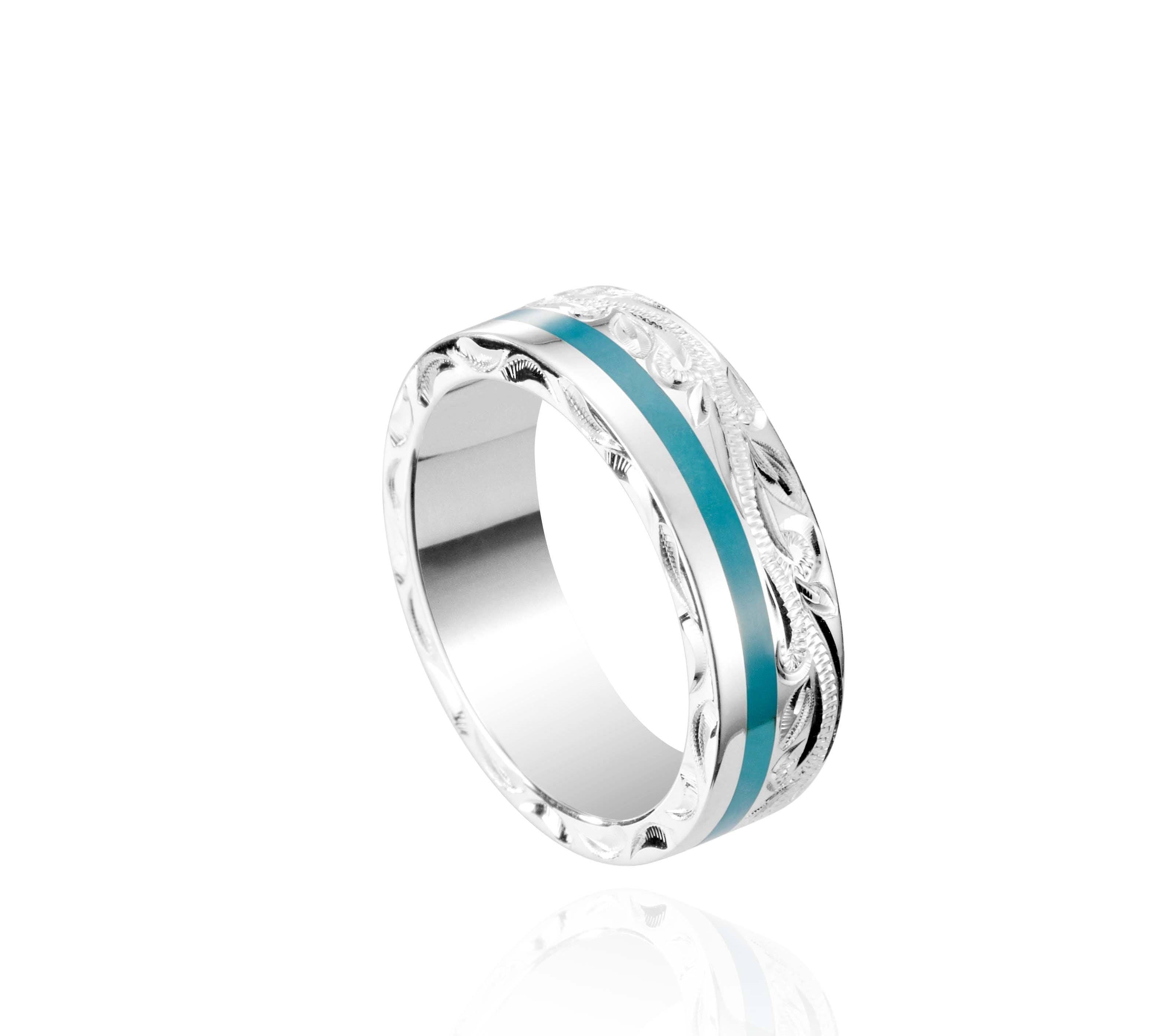 The picture shows a 925 sterling silver and turquoise wave channel ring with hand engravings.