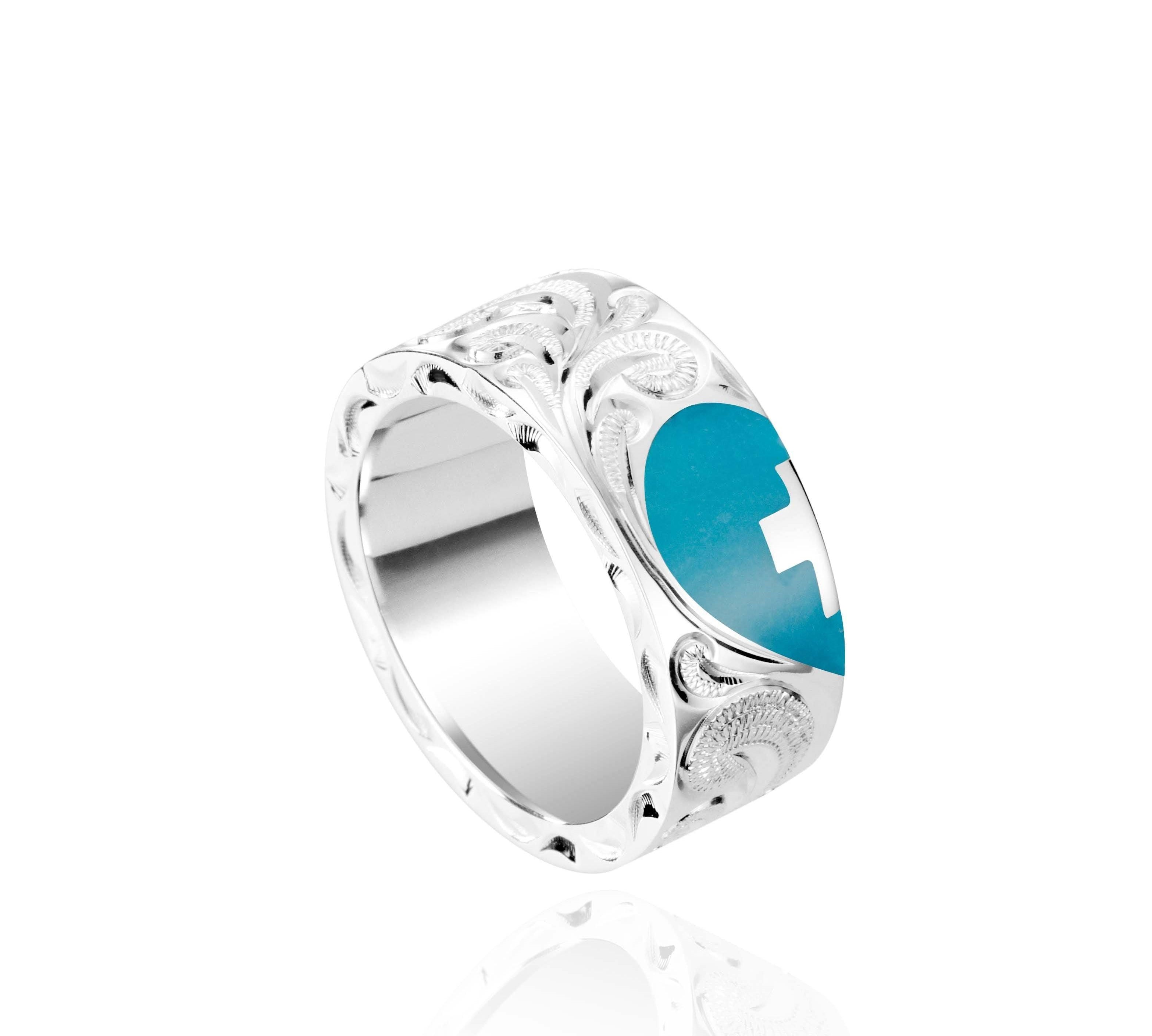 The picture shows a 925 sterling silver and turquoise heart with a cross matching ring with hand engravings.