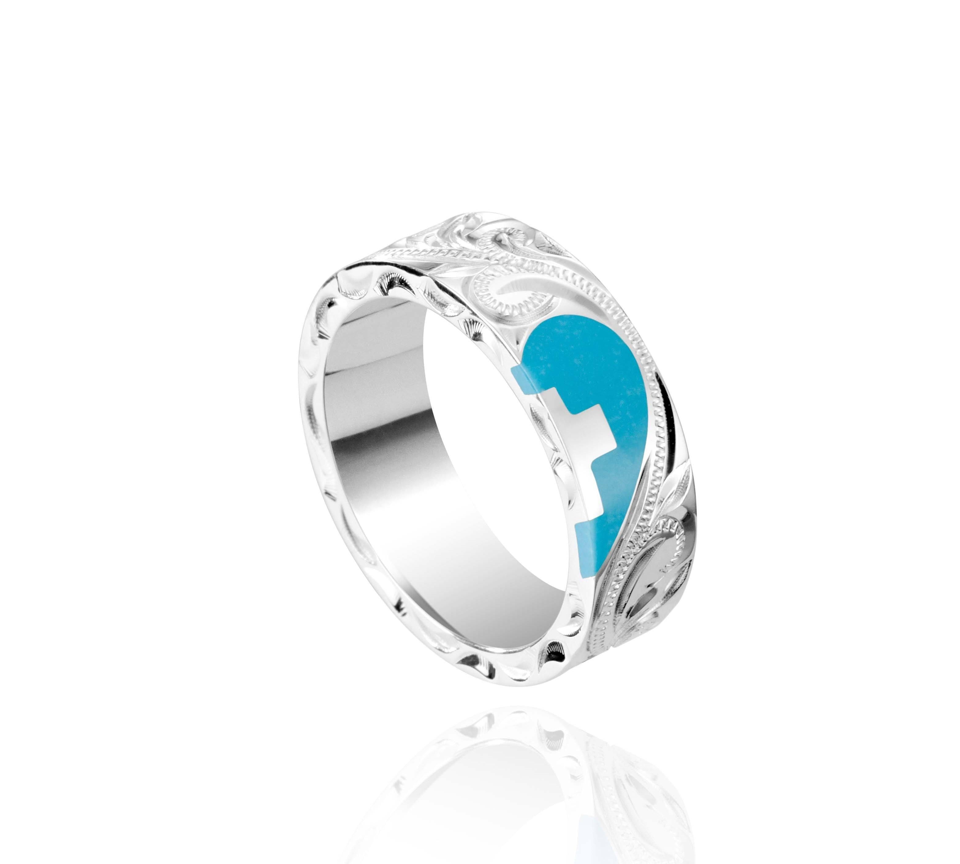 The picture shows a 925 sterling silver and turquoise heart with a cross matching ring with hand engravings.