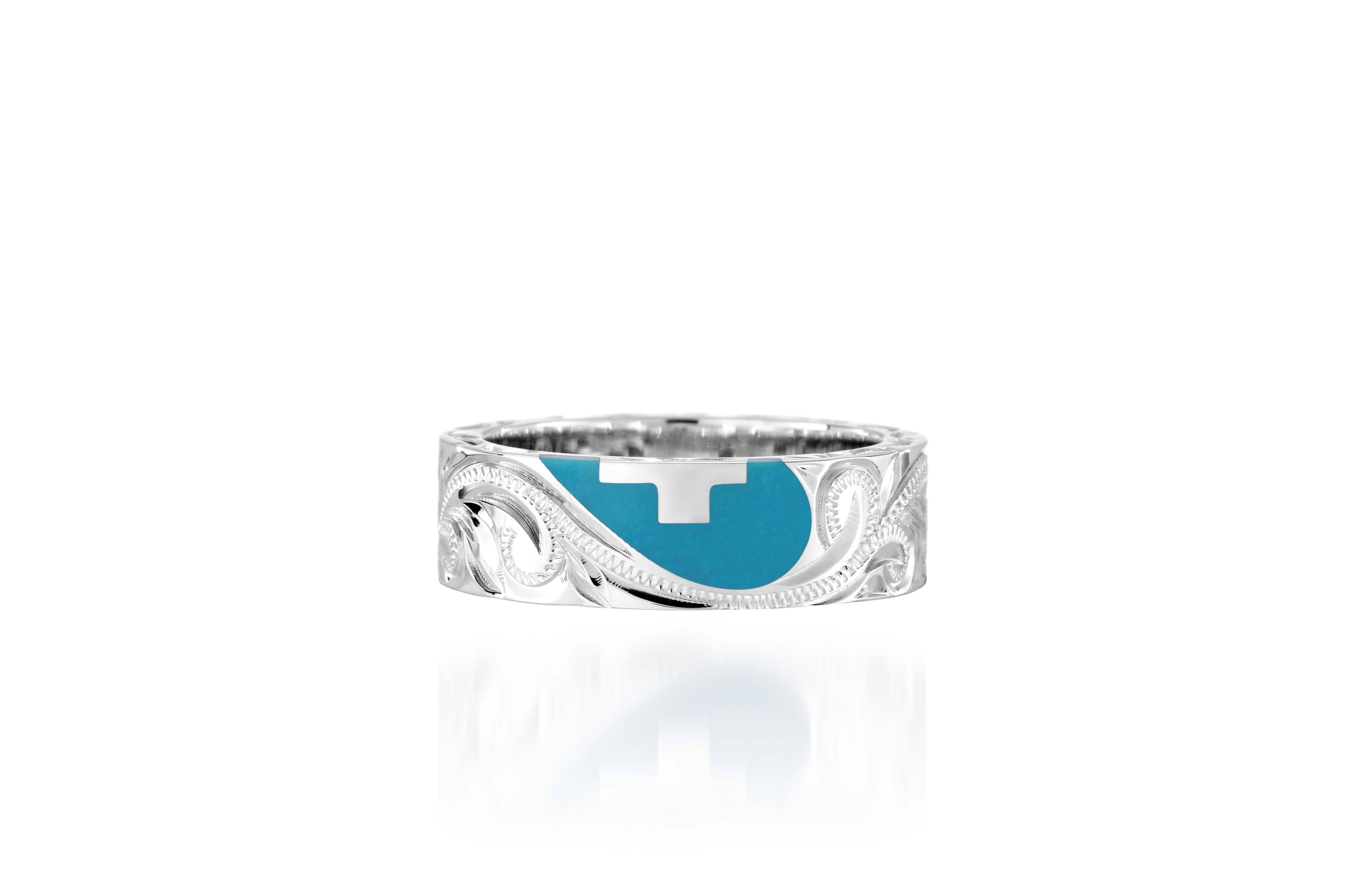 The picture shows a 925 sterling silver and turquoise heart with a cross matching ring with hand engravings.